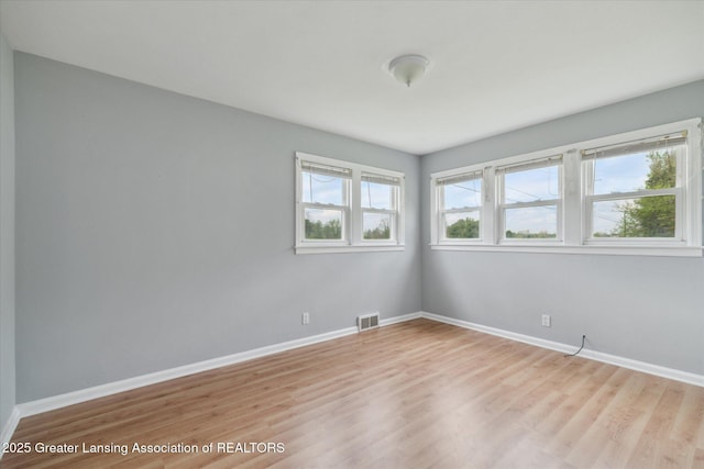 2468 Lansing Rd, Charlotte, MI 48813 - unfurnished room with light wood-style floors and baseboards