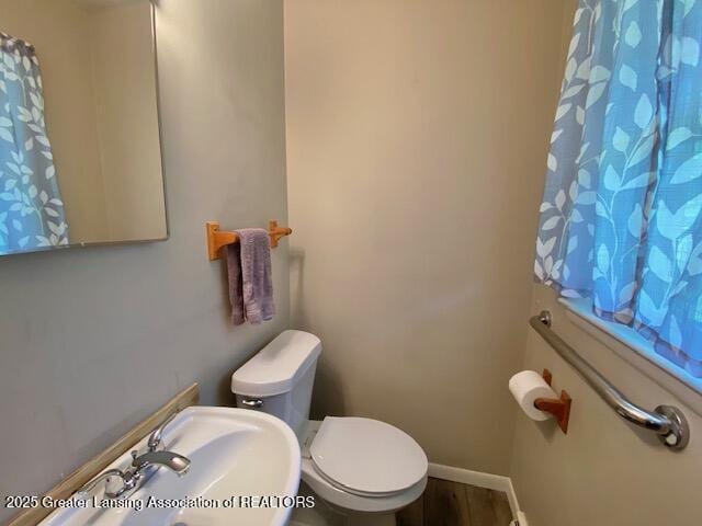 15426 Boichot Rd, Lansing, MI 48906 - bathroom with a sink, toilet, baseboards, and curtained shower