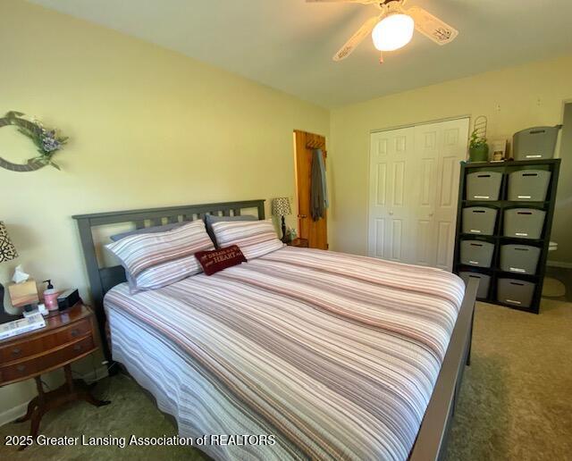 15426 Boichot Rd, Lansing, MI 48906 - carpeted bedroom with a closet and a ceiling fan