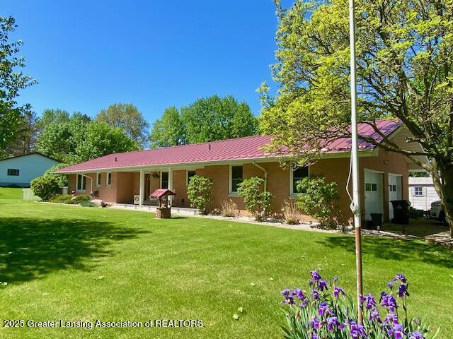 15426 Boichot Rd, Lansing, MI 48906 - view of front facade featuring a front lawn and metal roof