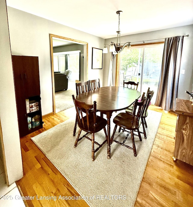 1211 W Thomas L Pkwy, Lansing, MI 48917 - dining room featuring light wood-style floors and a chandelier