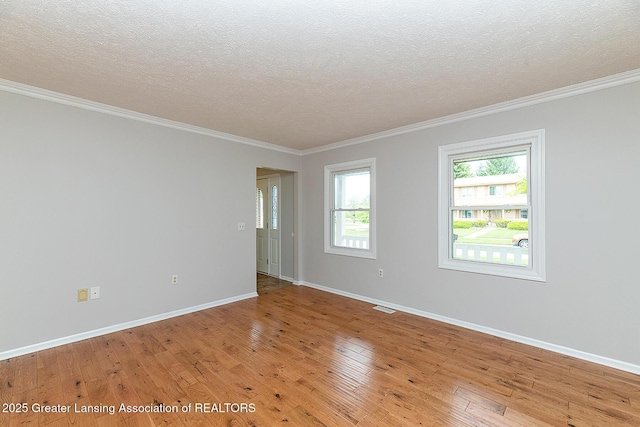 3979 Dayspring Ct, Okemos, MI 48864 - spare room with light wood-style floors, a textured ceiling, ornamental molding, and baseboards