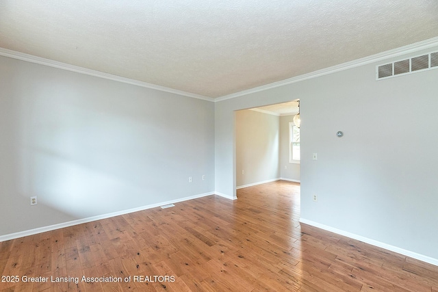 3979 Dayspring Ct, Okemos, MI 48864 - empty room featuring ornamental molding, light wood-style flooring, baseboards, and a textured ceiling