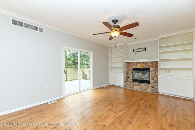 3979 Dayspring Ct, Okemos, MI 48864 - unfurnished living room featuring light wood finished floors, a ceiling fan, ornamental molding, baseboards, and a stone fireplace