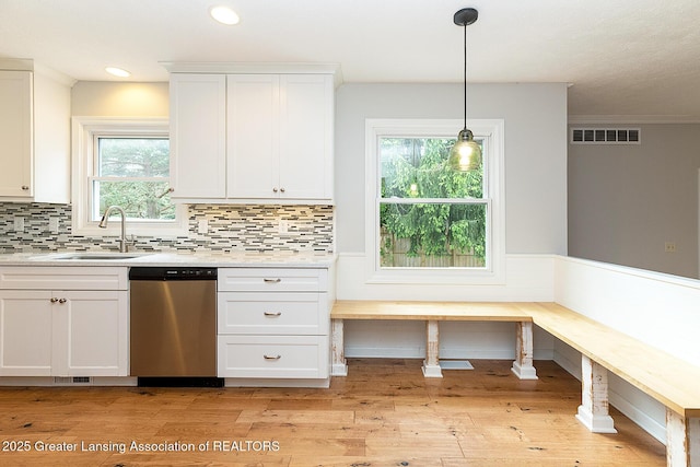 3979 Dayspring Ct, Okemos, MI 48864 - kitchen with dishwasher, a sink, white cabinets, light wood-style floors, and light countertops