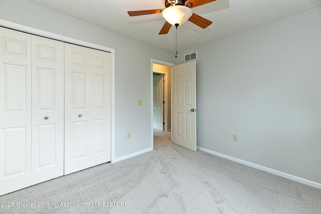 3979 Dayspring Ct, Okemos, MI 48864 - unfurnished bedroom with light carpet, a closet, baseboards, a textured ceiling, and a ceiling fan