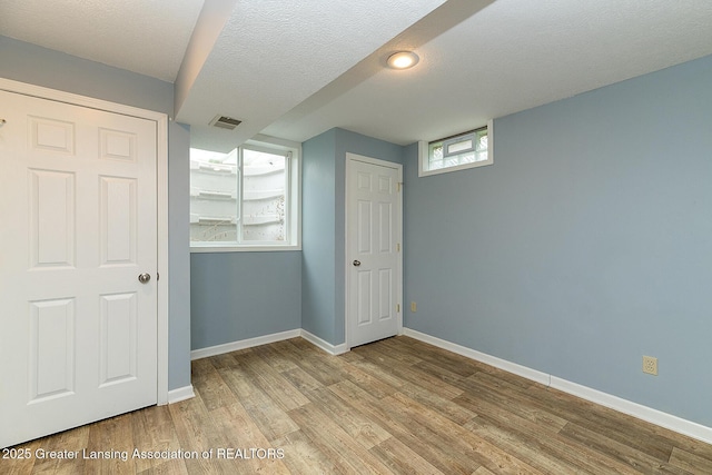 3979 Dayspring Ct, Okemos, MI 48864 - unfurnished bedroom featuring wood finished floors and baseboards