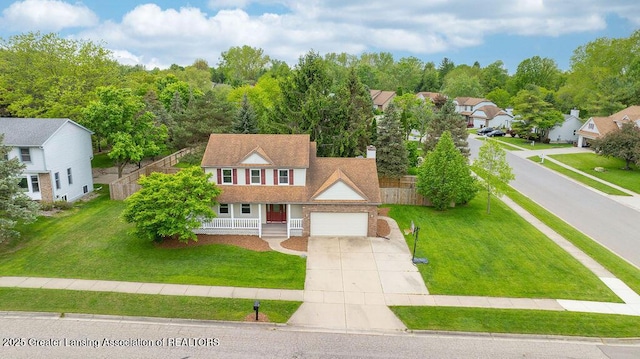 3979 Dayspring Ct, Okemos, MI 48864 - view of front of property with a porch, concrete driveway, a residential view, and a chimney