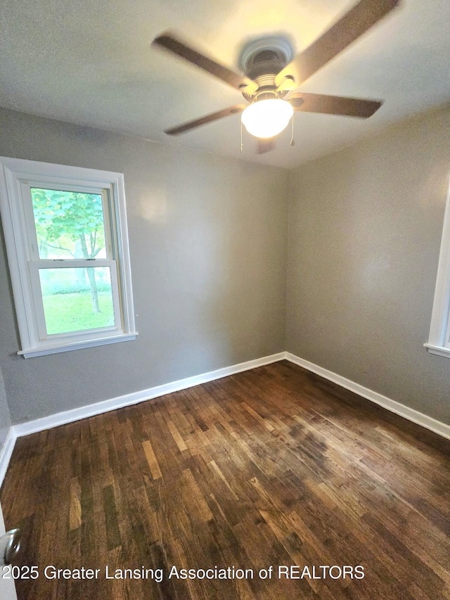 1427 Sheldon St, Lansing, MI 48906 - unfurnished room featuring dark wood finished floors, baseboards, and ceiling fan
