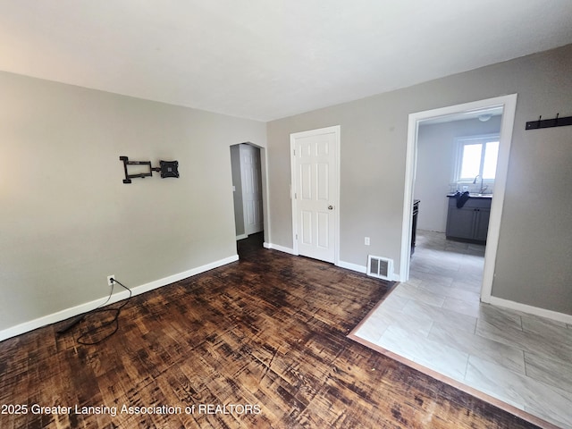 1427 Sheldon St, Lansing, MI 48906 - unfurnished room with baseboards and a sink