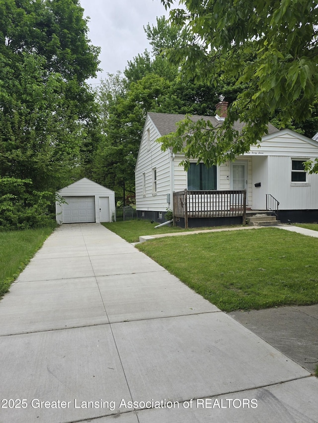 1427 Sheldon St, Lansing, MI 48906 - view of front of property with covered porch, a detached garage, a chimney, a front lawn, and an outdoor structure