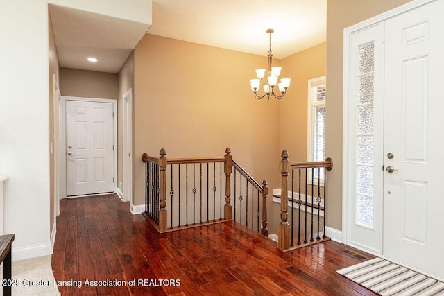 4655 Dimond Way, Dimondale, MI 48821 - entryway with a chandelier, baseboards, and wood-type flooring