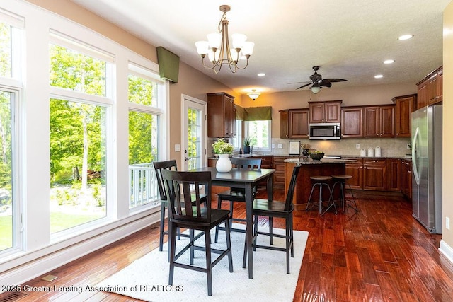 4655 Dimond Way, Dimondale, MI 48821 - dining area with a chandelier, dark wood finished floors, recessed lighting, and ceiling fan