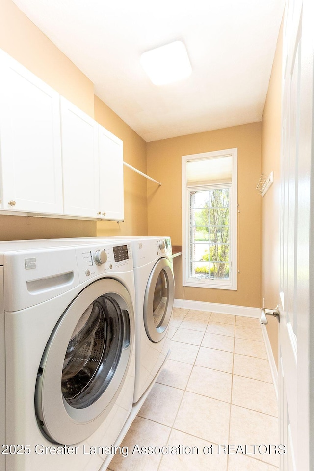 4655 Dimond Way, Dimondale, MI 48821 - laundry room featuring separate washer and dryer, cabinet space, light tile patterned flooring, and baseboards