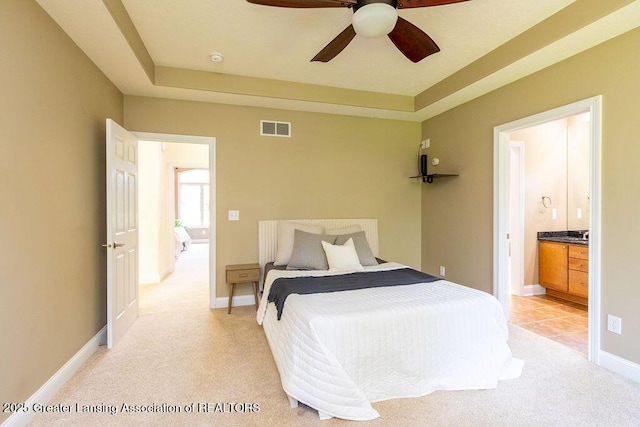 4655 Dimond Way, Dimondale, MI 48821 - bedroom featuring light carpet, ensuite bathroom, baseboards, a ceiling fan, and a raised ceiling