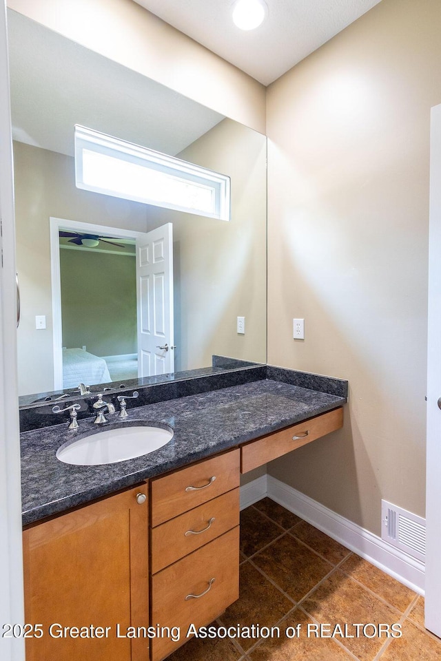 4655 Dimond Way, Dimondale, MI 48821 - bathroom with tile patterned flooring, vanity, and baseboards