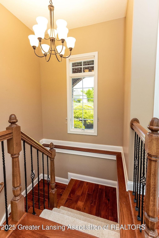 4655 Dimond Way, Dimondale, MI 48821 - staircase with wood finished floors, a chandelier, and baseboards