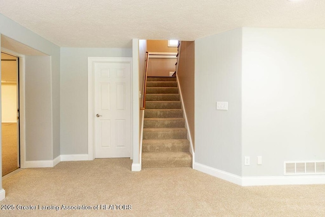 4655 Dimond Way, Dimondale, MI 48821 - stairs with carpet, a textured ceiling, and baseboards