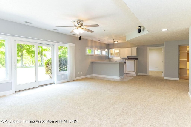 4655 Dimond Way, Dimondale, MI 48821 - unfurnished living room featuring light carpet, baseboards, a ceiling fan, and recessed lighting