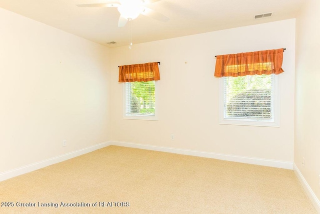 4655 Dimond Way, Dimondale, MI 48821 - spare room with light colored carpet, ceiling fan, and baseboards