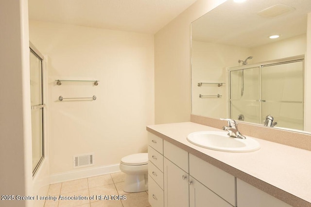 4655 Dimond Way, Dimondale, MI 48821 - full bathroom featuring a shower with shower door, toilet, tile patterned flooring, vanity, and baseboards