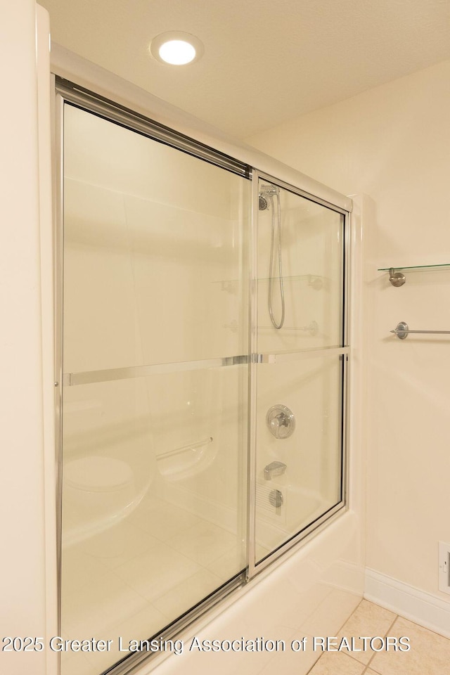 4655 Dimond Way, Dimondale, MI 48821 - full bath featuring tile patterned flooring, combined bath / shower with glass door, and baseboards