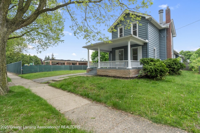 828 Backus St, Jackson, MI 49202 - view of front facade with a porch and a chimney