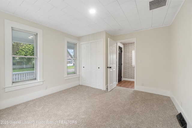 828 Backus St, Jackson, MI 49202 - carpeted empty room featuring plenty of natural light and baseboards