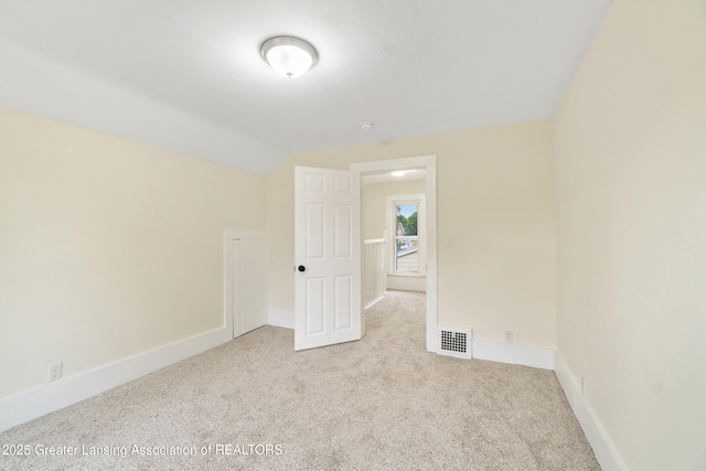 828 Backus St, Jackson, MI 49202 - empty room with carpet flooring, lofted ceiling, and baseboards
