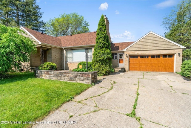 224 S Grace St, Lansing, MI 48917 - ranch-style house with a garage, brick siding, driveway, a chimney, and a front yard