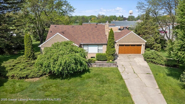 224 S Grace St, Lansing, MI 48917 - view of front of home featuring a chimney, a front lawn, and an attached garage