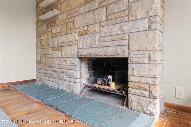 224 S Grace St, Lansing, MI 48917 - detailed view of a fireplace, wood finished floors, and baseboards