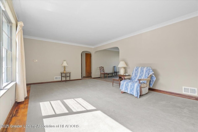 224 S Grace St, Lansing, MI 48917 - sitting room featuring arched walkways, ornamental molding, baseboards, and carpet