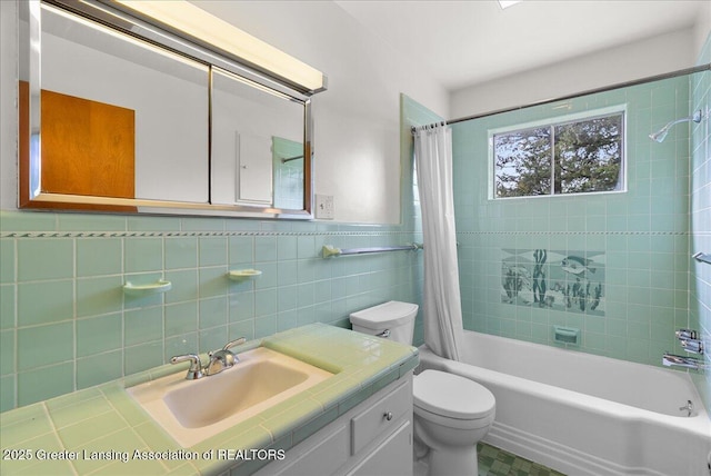 224 S Grace St, Lansing, MI 48917 - full bathroom with shower / bath combo with shower curtain, toilet, vanity, and tile walls