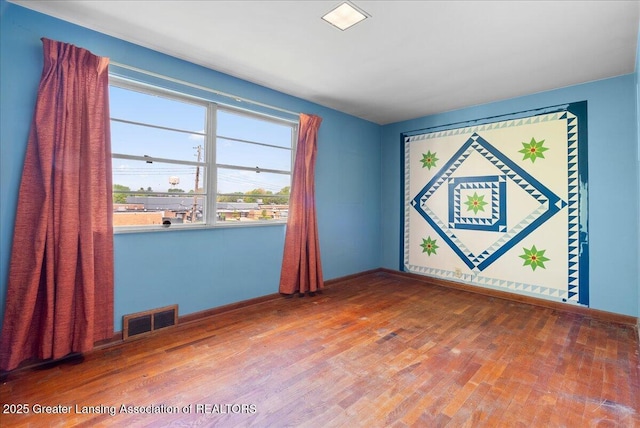224 S Grace St, Lansing, MI 48917 - empty room featuring wood finished floors and baseboards