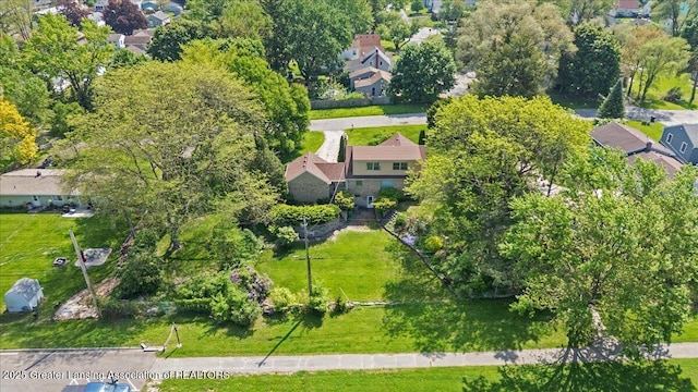 224 S Grace St, Lansing, MI 48917 - aerial view of property and surrounding area featuring nearby suburban area and a tree filled landscape