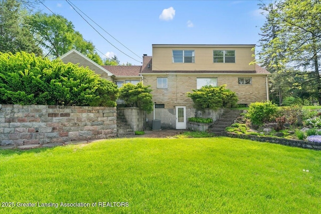 224 S Grace St, Lansing, MI 48917 - rear view of property with stairway, a yard, and central AC unit