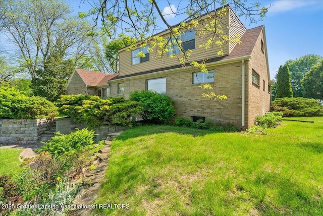 224 S Grace St, Lansing, MI 48917 - view of side of property with brick siding and a yard