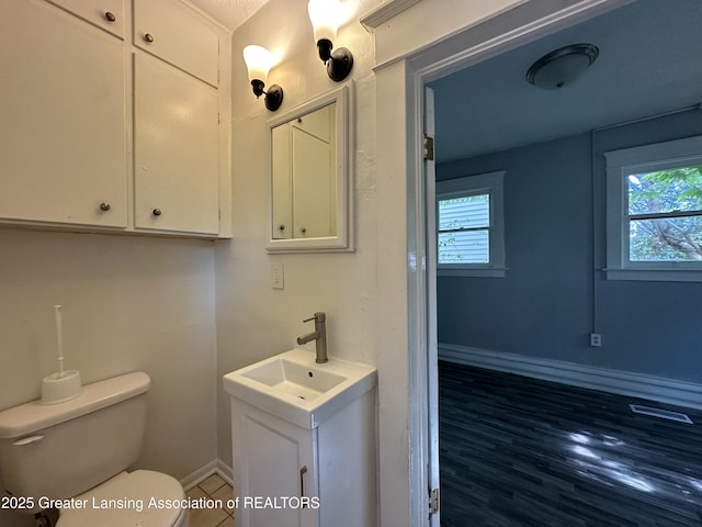 312 Jones St, Lansing, MI 48912 - bathroom with healthy amount of natural light, vanity, toilet, and baseboards