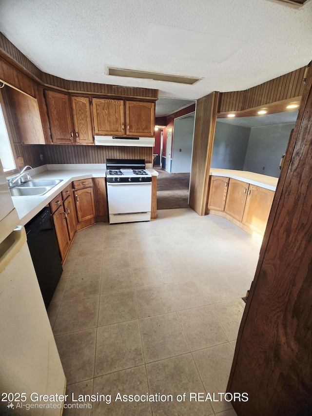 1279 Leland Rd, Ovid, MI 48866 - kitchen with white gas stove, a sink, under cabinet range hood, a textured ceiling, and black dishwasher