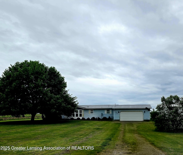 1279 Leland Rd, Ovid, MI 48866 - view of front facade featuring an attached garage, driveway, and a front lawn