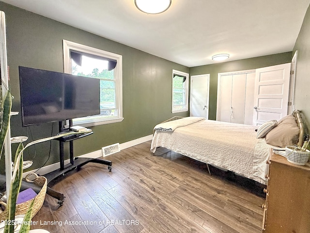 2215 Haslett Rd, East Lansing, MI 48823 - bedroom featuring wood finished floors and baseboards