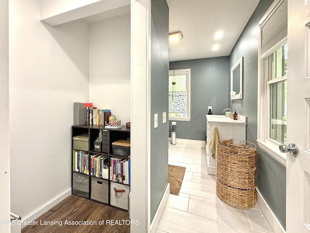 2215 Haslett Rd, East Lansing, MI 48823 - bathroom with vanity, plenty of natural light, baseboards, wood finished floors, and recessed lighting