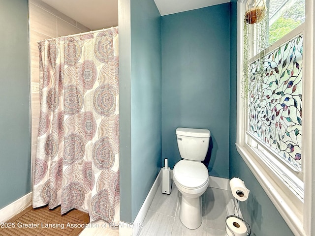 2215 Haslett Rd, East Lansing, MI 48823 - full bath with toilet, baseboards, and a shower with curtain