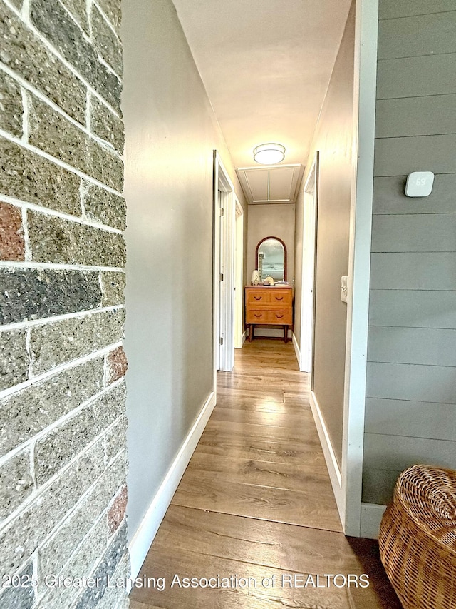 2215 Haslett Rd, East Lansing, MI 48823 - hallway with attic access, wood finished floors, and baseboards