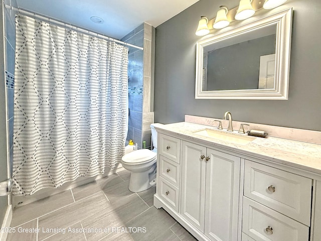 2215 Haslett Rd, East Lansing, MI 48823 - bathroom featuring vanity, toilet, shower / bath combination with curtain, and tile patterned flooring