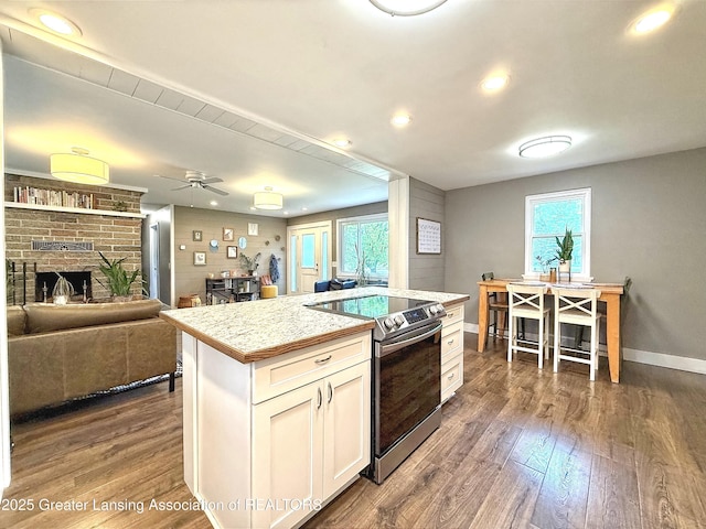 2215 Haslett Rd, East Lansing, MI 48823 - kitchen with stainless steel range with electric stovetop, dark wood-type flooring, recessed lighting, light countertops, and baseboards