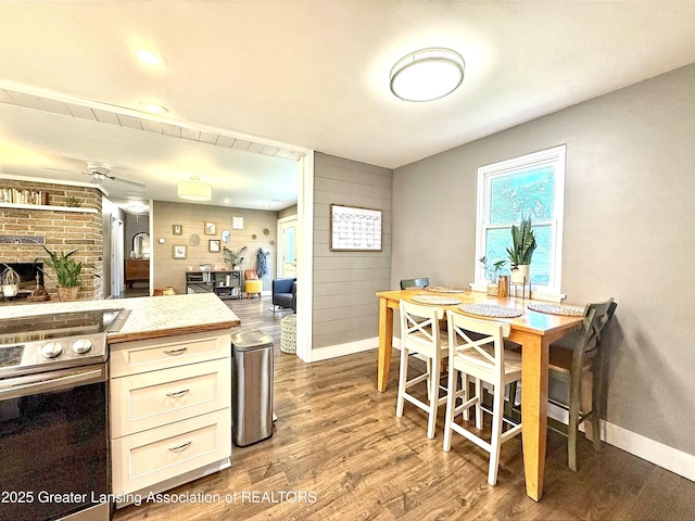 2215 Haslett Rd, East Lansing, MI 48823 - dining room with baseboards, wood finished floors, and a brick fireplace