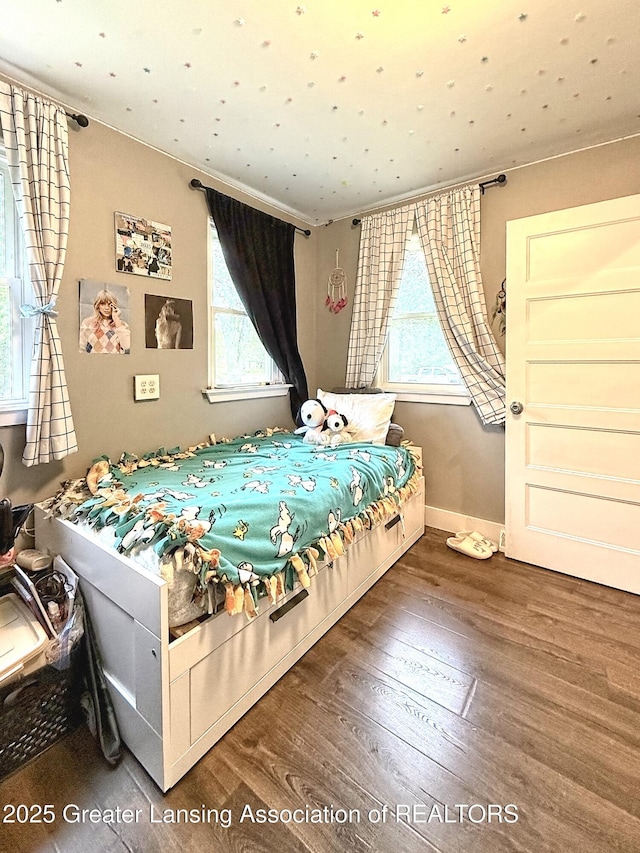 2215 Haslett Rd, East Lansing, MI 48823 - bedroom featuring wood finished floors, multiple windows, and baseboards