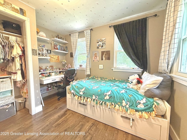 2215 Haslett Rd, East Lansing, MI 48823 - bedroom with wood finished floors and an office area